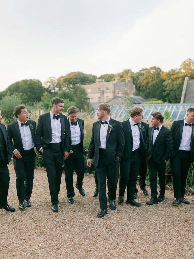 Groom and groomsmen walking together at Ripple Court Estate wedding in Kent