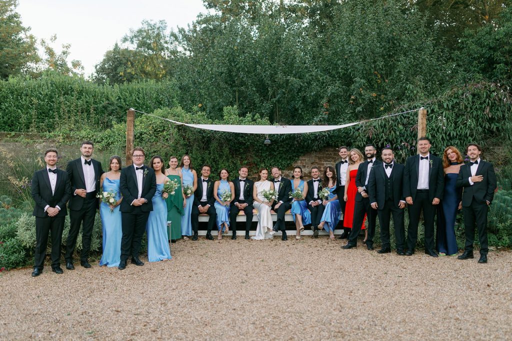 Bride and groom with bridesmaids and groomsmen during wedding party portraits