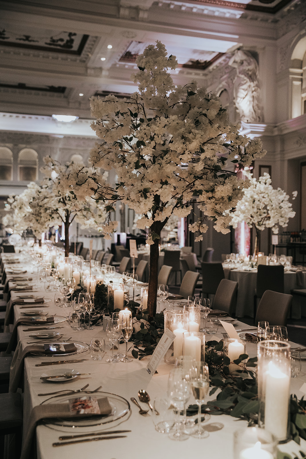 Wedding reception tables styled with candles and floral centrepieces at Kimpton Fitzroy London
